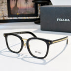 Prada eyeglasses with black full-rim rectangular frames and gold metal accents.