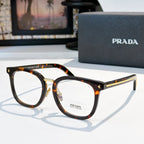 Prada eyeglasses with tortoise full-rim rectangular frames and gold metal temples.