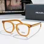 Prada eyeglasses with honey-tan full-rim rectangular frames and gold metal temples.