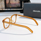 Prada eyeglasses side profile with honey-tan full-rim frames and gold metal temples.