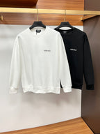 Two crewneck sweatshirts, white and black, each with VERSACE logo