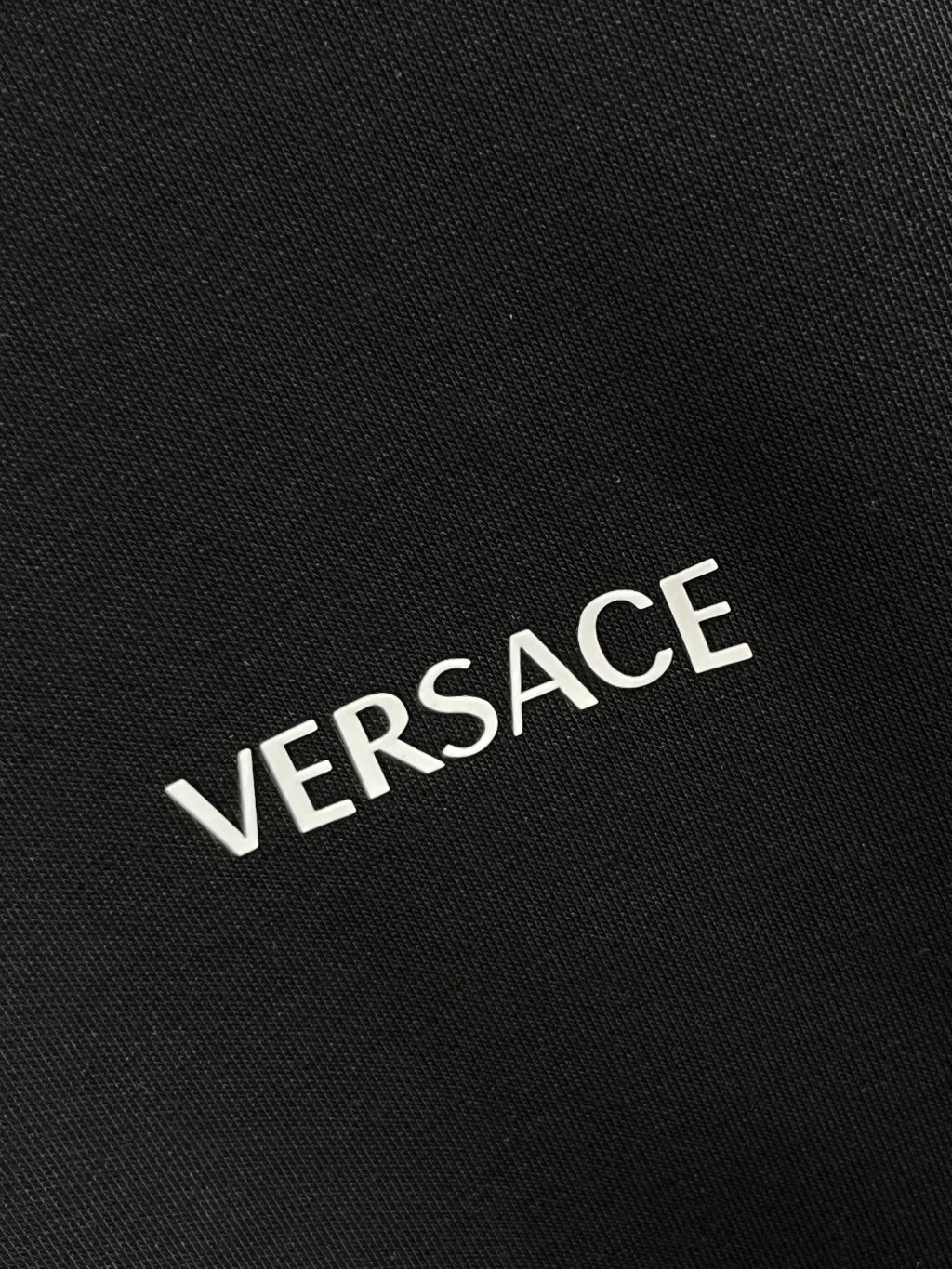 VERSACE logo print on dark gray sweatshirt fabric