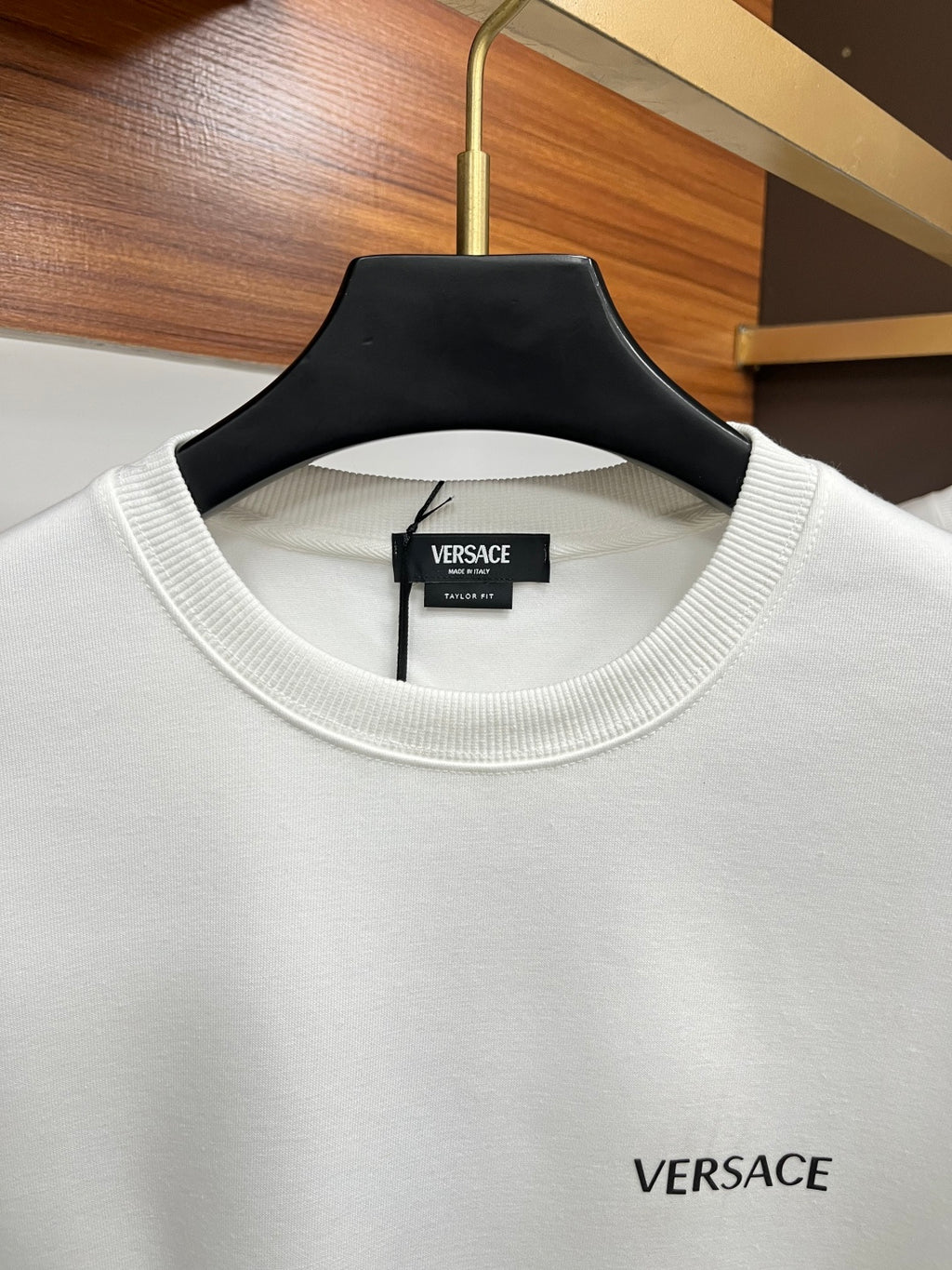 White Versace crewneck sweatshirt with ribbed collar and chest logo.