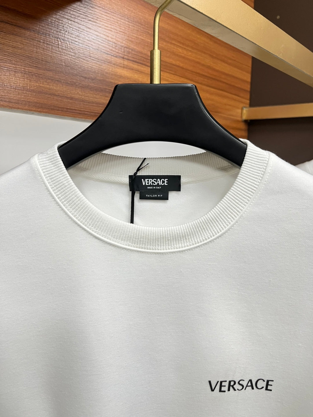 White Versace crewneck sweatshirt with ribbed collar and chest logo.
