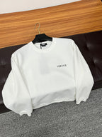 White Versace crewneck sweatshirt with small chest logo and long sleeves.