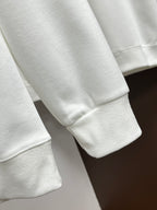 White Versace sweatshirt sleeve with ribbed cuff.