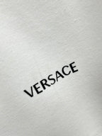 VERSACE logo print on white sweatshirt fabric.