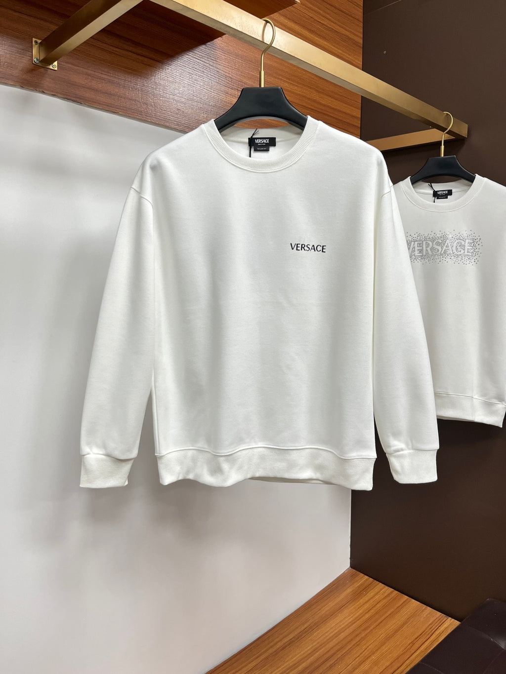 White Versace crewneck sweatshirt with small chest logo.