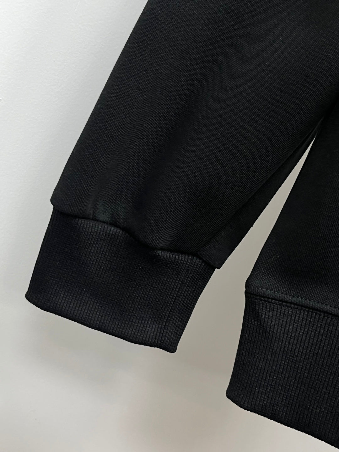 Black sweatshirt sleeve and ribbed hem cuff