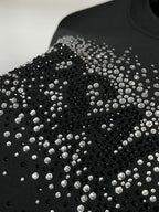 Black sweatshirt with dense rhinestone stud pattern across the front