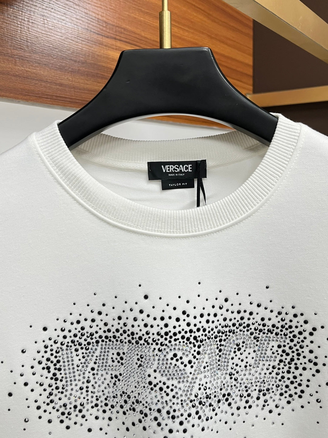 White crewneck collar with rhinestone logo across chest