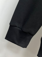 Black crewneck sweatshirt sleeve cuff detail