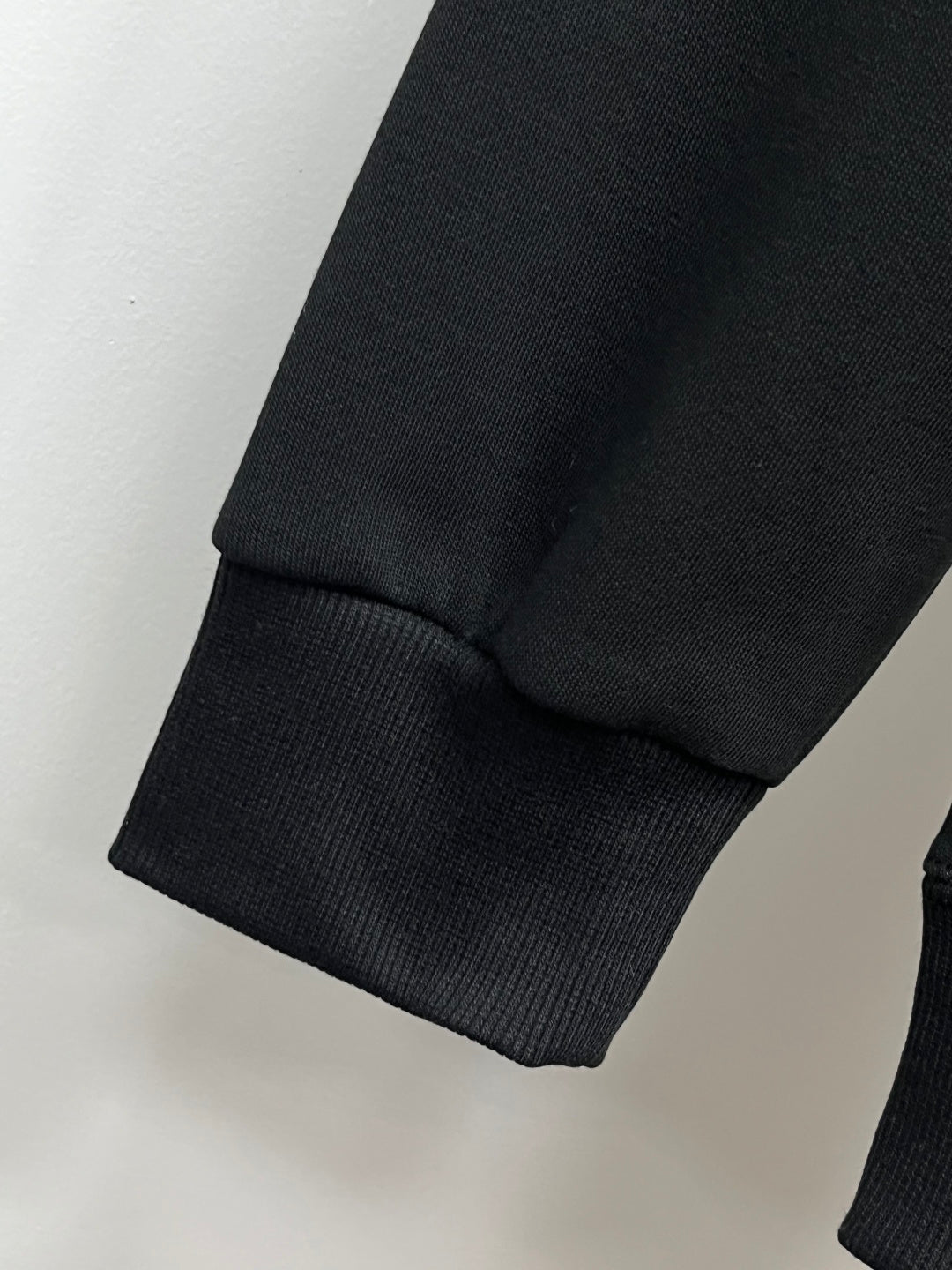 Black crewneck sweatshirt sleeve cuff detail