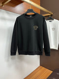 Black crewneck sweatshirt with gold-tone studded lion head on chest
