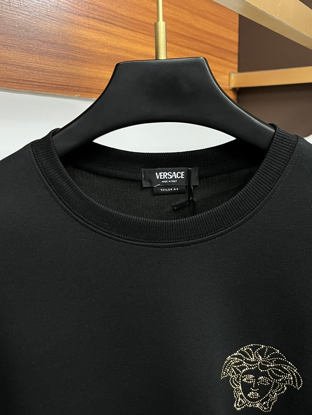 Black crewneck sweatshirt with VERSACE label and gold-tone studded lion head