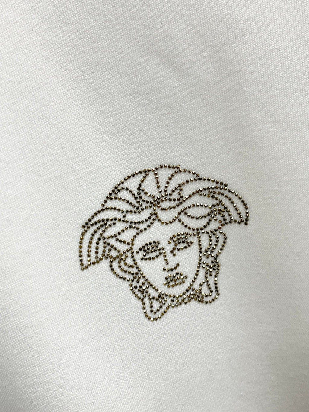Rhinestone Medusa logo on white Versace sweatshirt fabric