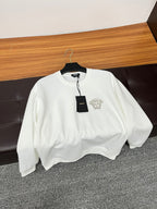 White Versace crewneck sweatshirt on hanger with Medusa logo and black tag