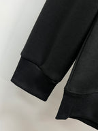 Black crewneck sweatshirt cuffs and ribbed hem detail