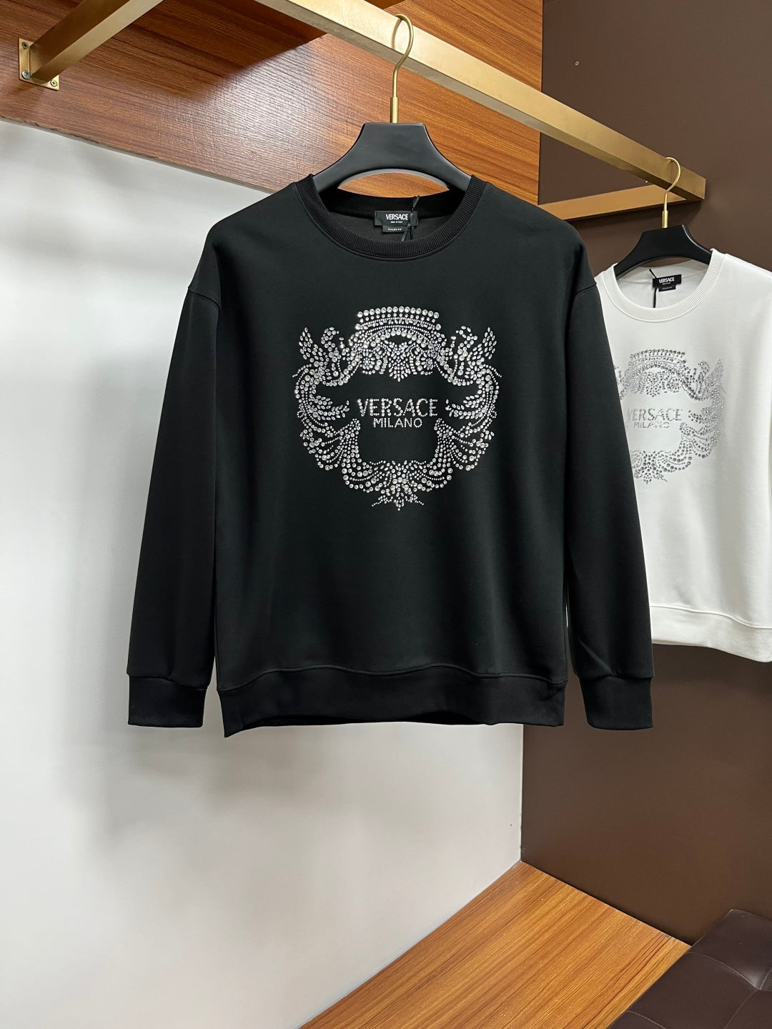 Black crewneck sweatshirt with rhinestone VERSACE Milano crest graphic on front