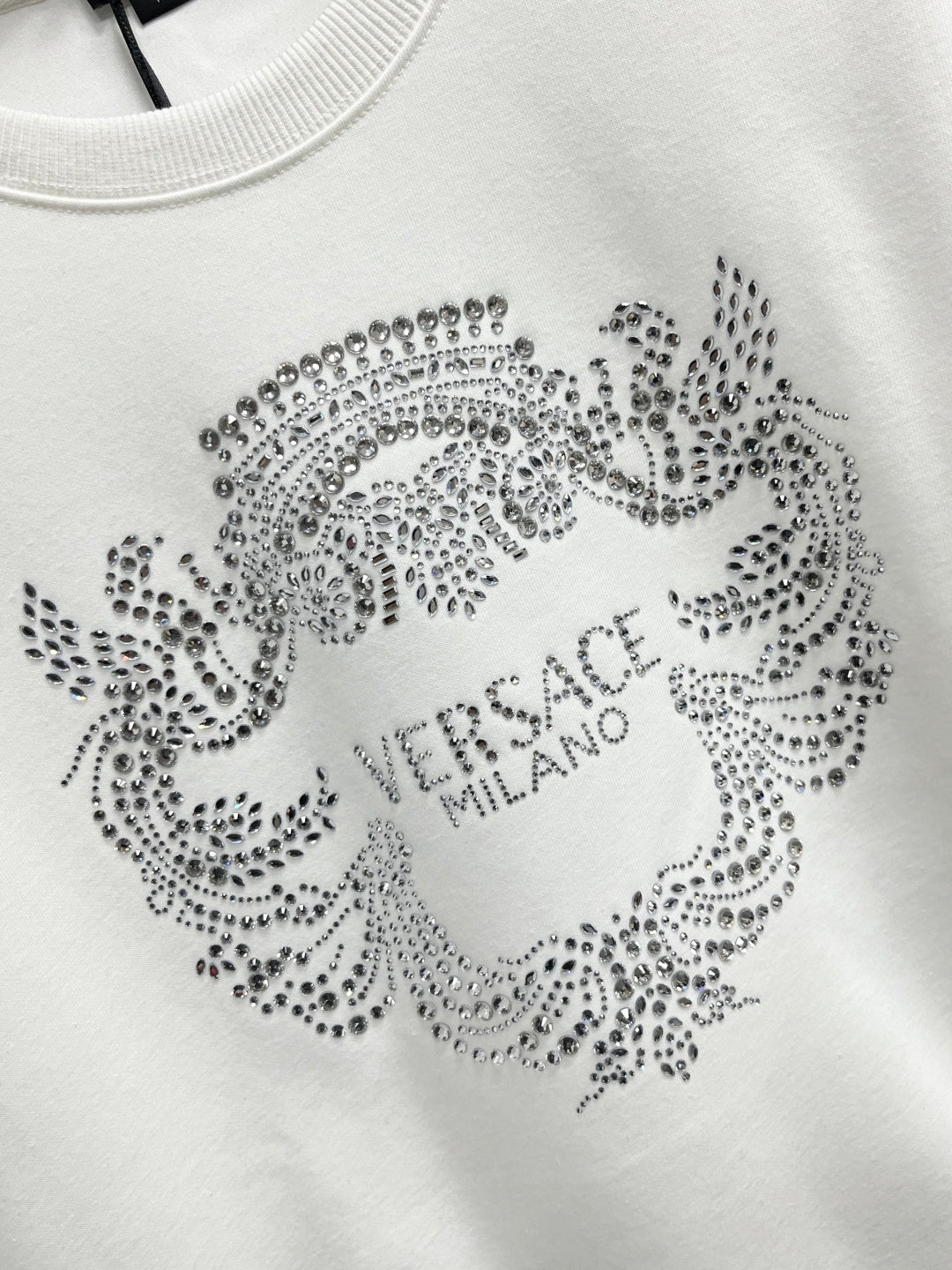 White sweatshirt with rhinestone circular crest and VERSACE MILANO