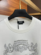 White crewneck sweatshirt with ribbed neckline and rhinestone crest logo