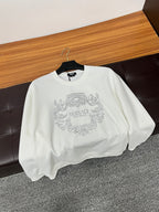 White crewneck sweatshirt with rhinestone crest logo on chest