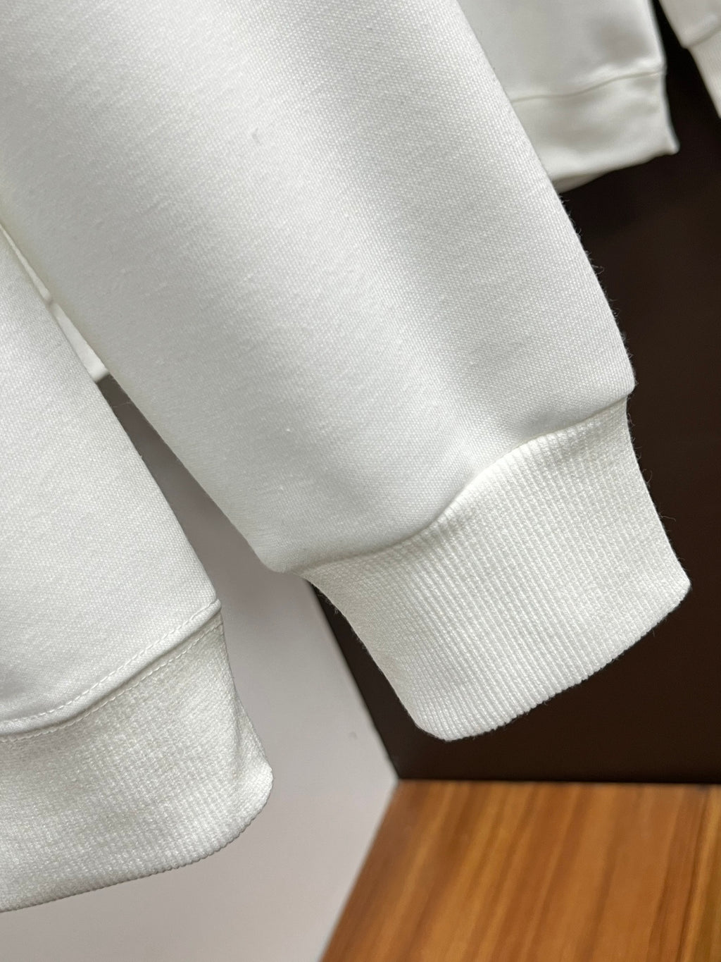 White sweatshirt sleeve and cuff detail