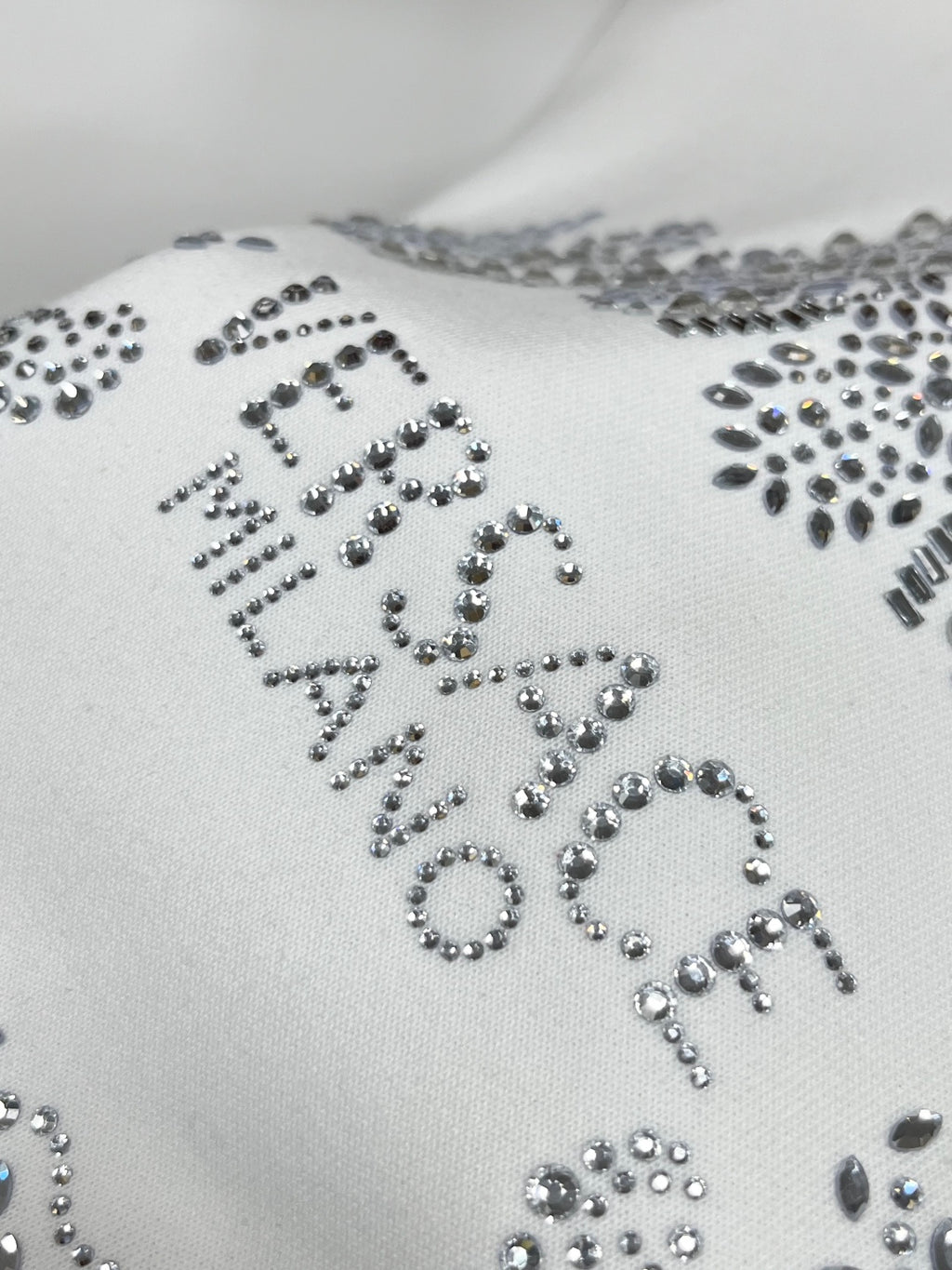 White sweatshirt with large rhinestone lettered design on front