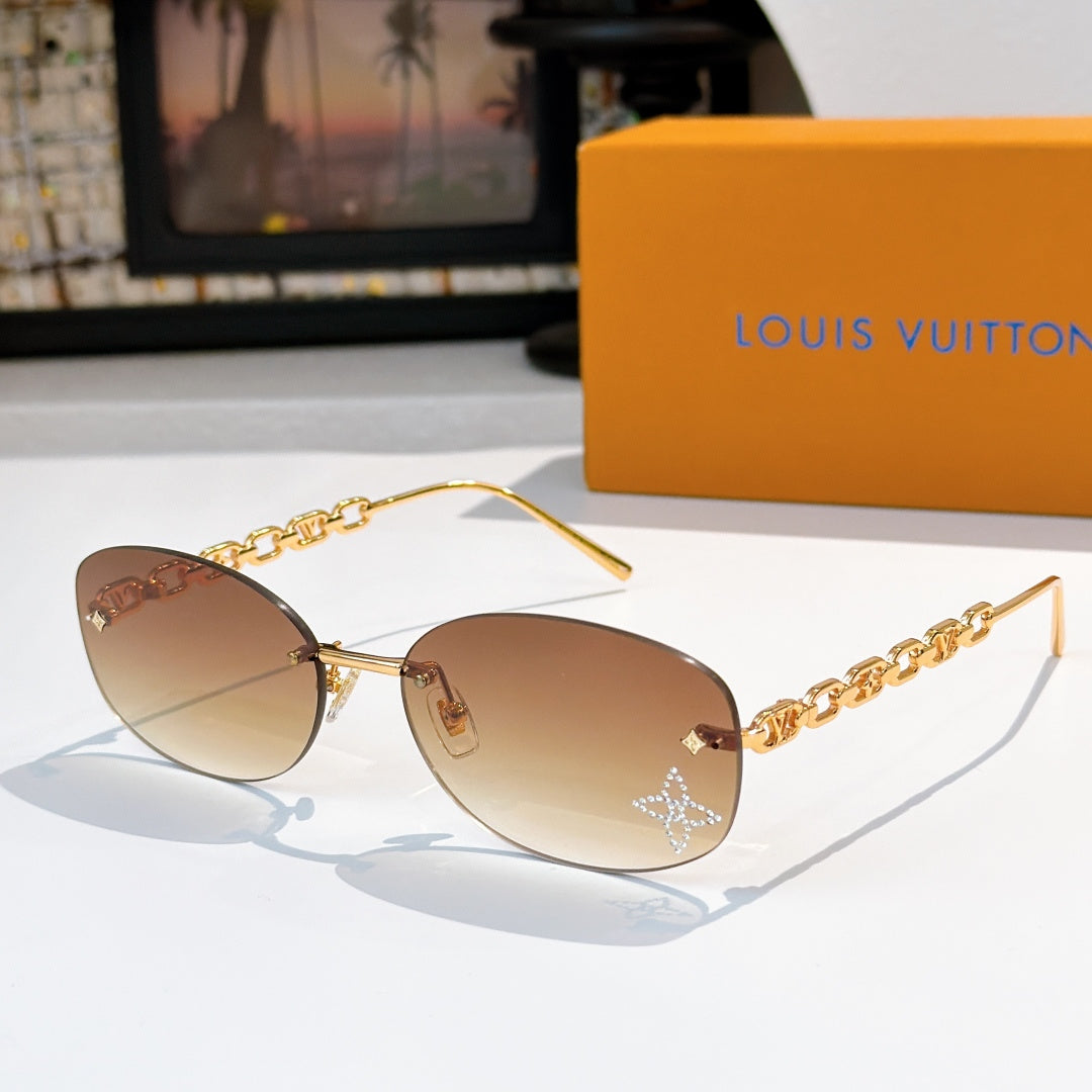 Louis Vuitton sunglasses with gold chain temples and light tan gradient lenses, star detail