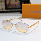 Louis Vuitton sunglasses with gold chain temples and pale yellow gradient lenses, star detail