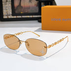 Louis Vuitton sunglasses with gold chain temples and amber gradient lenses, star detail