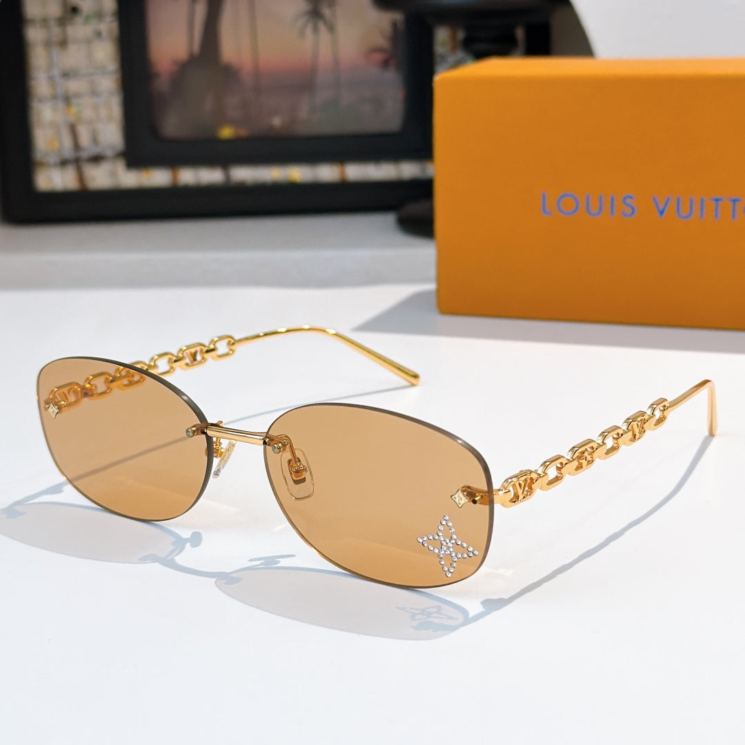 Louis Vuitton sunglasses with gold chain temples and amber gradient lenses, star detail