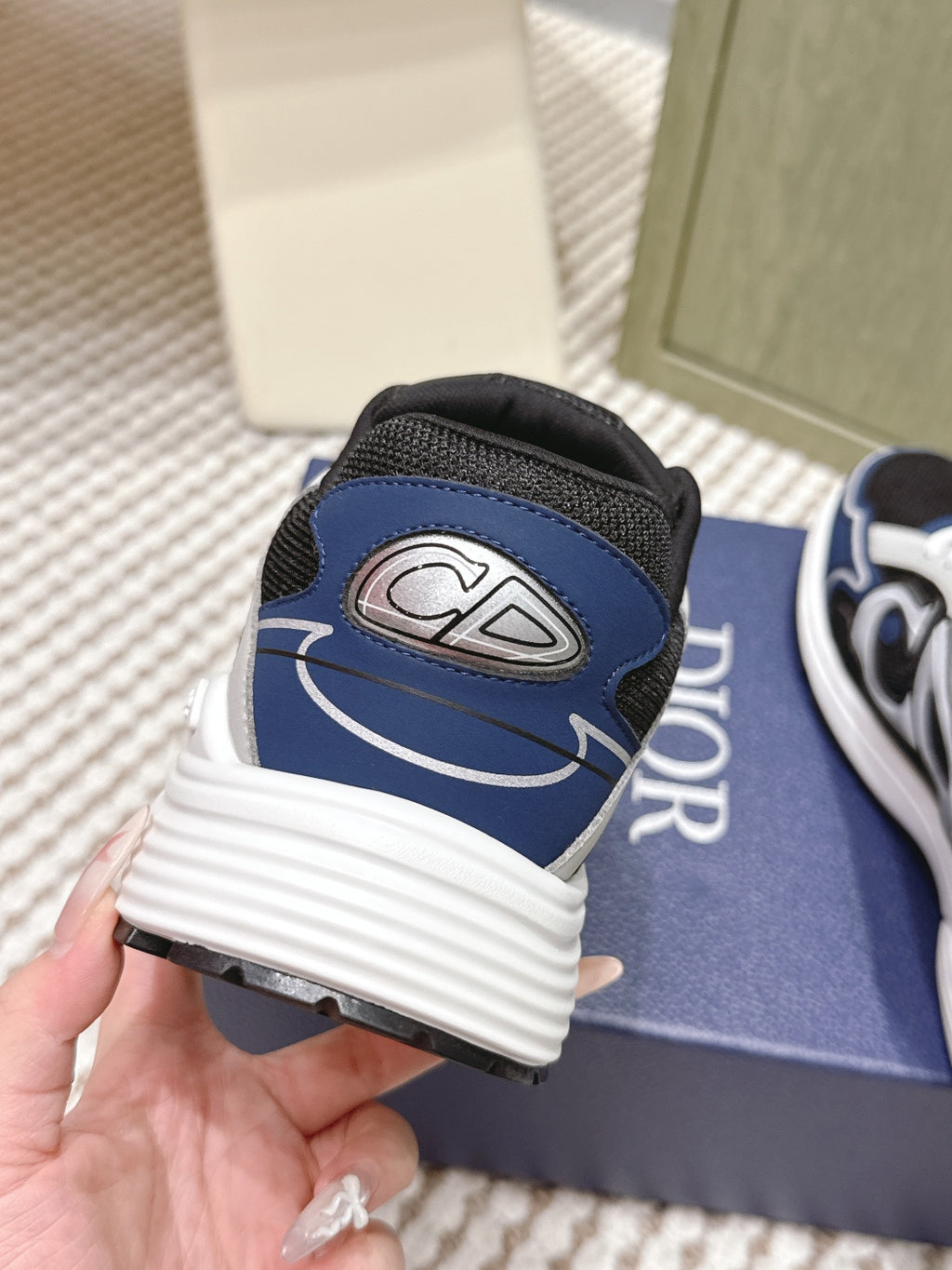 Dior unisex sneaker heel close-up, blue and black with white ribbed midsole