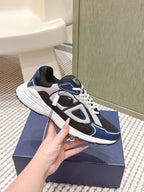 Dior unisex sneakers, side view showing navy, black, and white color-blocking
