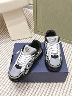 White and navy Dior sneakers with black toe cap and white lace-up.