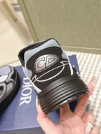Dior sneakers side view with ribbed sole and DIOR lettering on the upper.