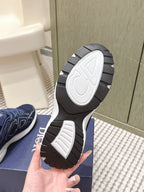 Dior unisex sneaker outsole view with tread and white sole edge on blue box