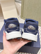 Back view of navy Dior unisex sneakers with rear branding and white striped sole