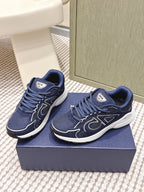 Pair of navy Dior unisex sneakers with lace-up vamps and white midsoles