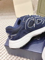 Navy Dior unisex sneaker side view with textured paneling and ribbed white sole