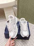 White Dior sneakers, side and heel close-up, showing laces and logo tongue label.