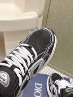 Black Dior unisex sneaker top view on blue box, white laces