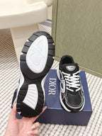 Black Dior unisex sneakers with one sole shown, bottom and side view