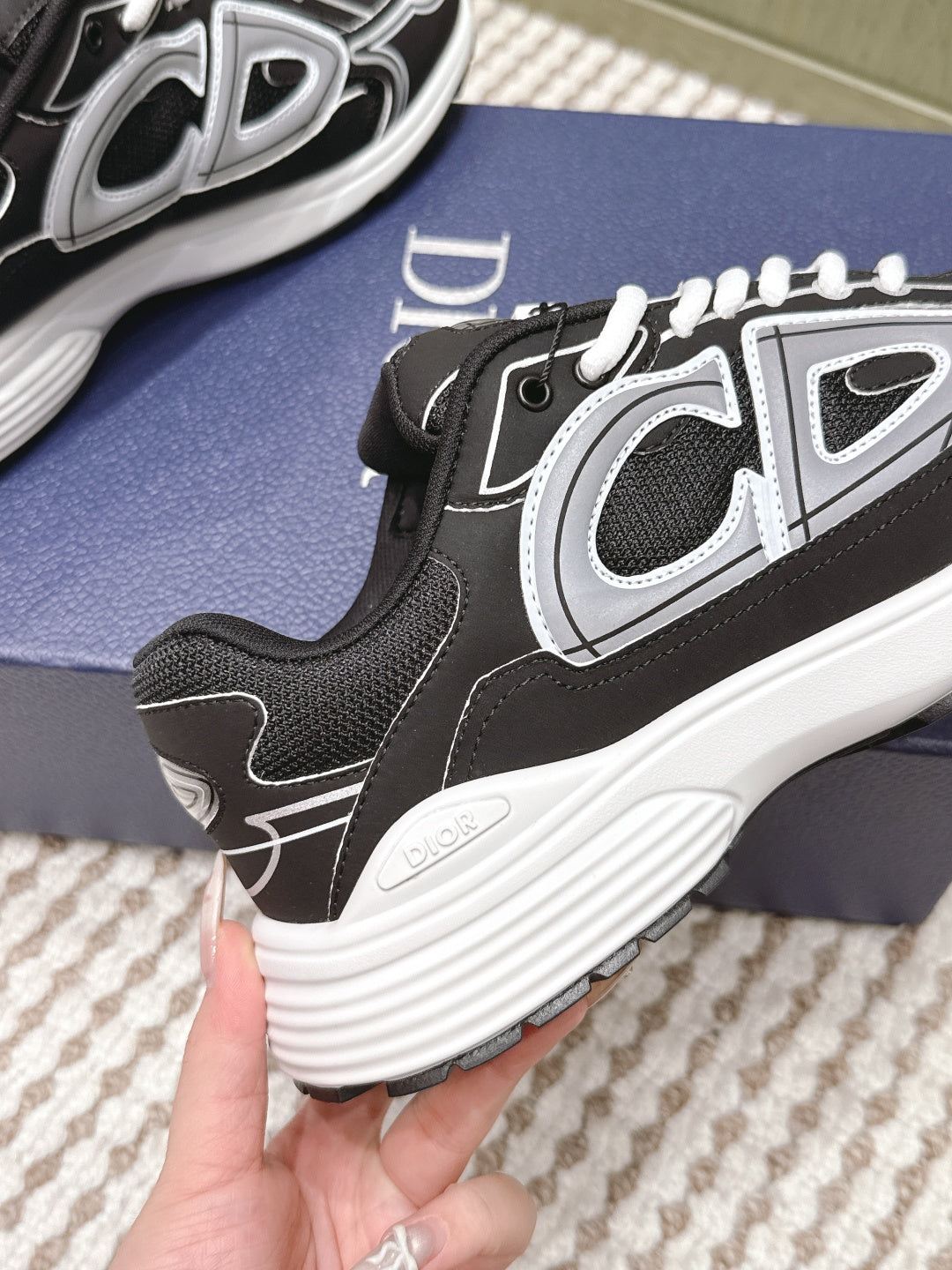 Black Dior unisex sneaker heel and side panel close-up, white trim