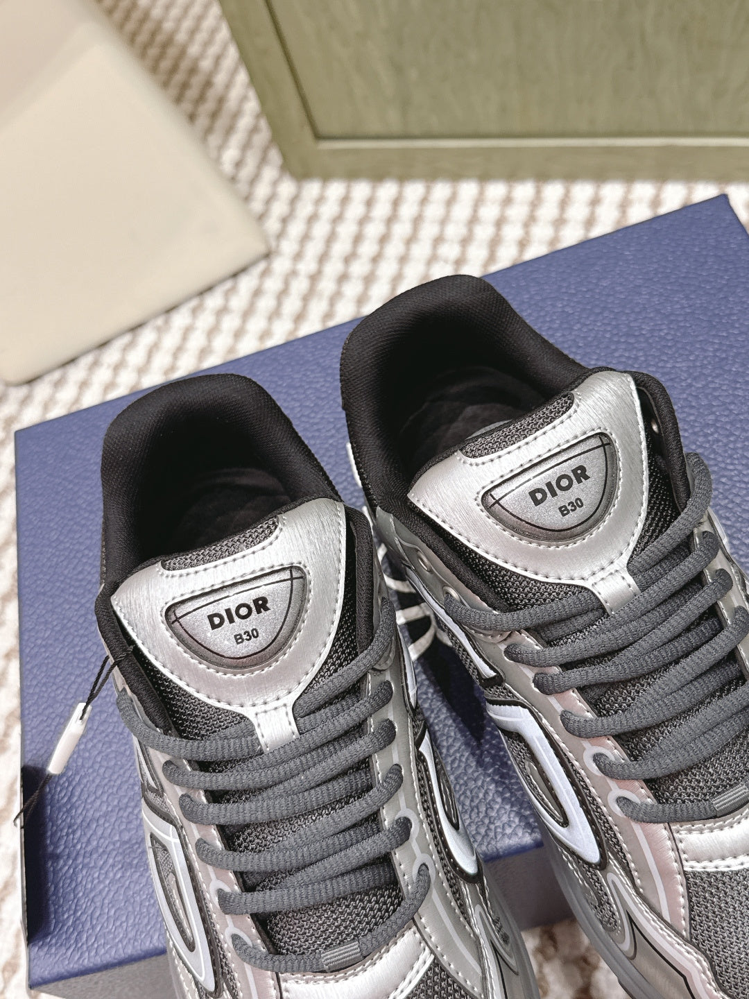 Dior sneakers pair view, grey uppers with white panels and Dior logo on tongue