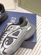 Dior sneakers close-up, grey and silver with ribbed rubber sole and lace-up front