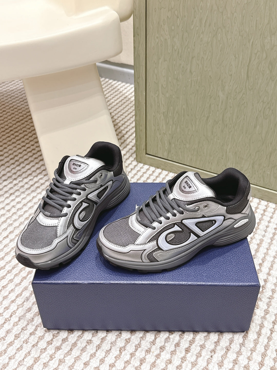 Dior unisex sneakers, side view, grey and white with black tongue and lace trim