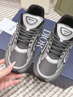 Dior unisex sneakers front view, grey mesh with white trim and logo on tongue