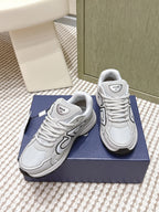 Unisex lace-up sneakers in light gray/white, angled view showing side panels and laces