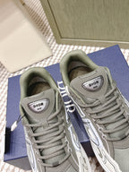 Close-up of grey sneakers with Dior logo tongue labels and white soles